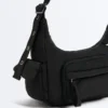 Mini-Tasche mit Maxi-Taschen Mini-Tasche mit Maxi-Taschen