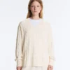 Pullover aus 100 % Baumwolle mit Zopfmuster und V-Ausschnitt Pullover aus 100 % Baumwolle mit Zopfmuster und V-Ausschnitt